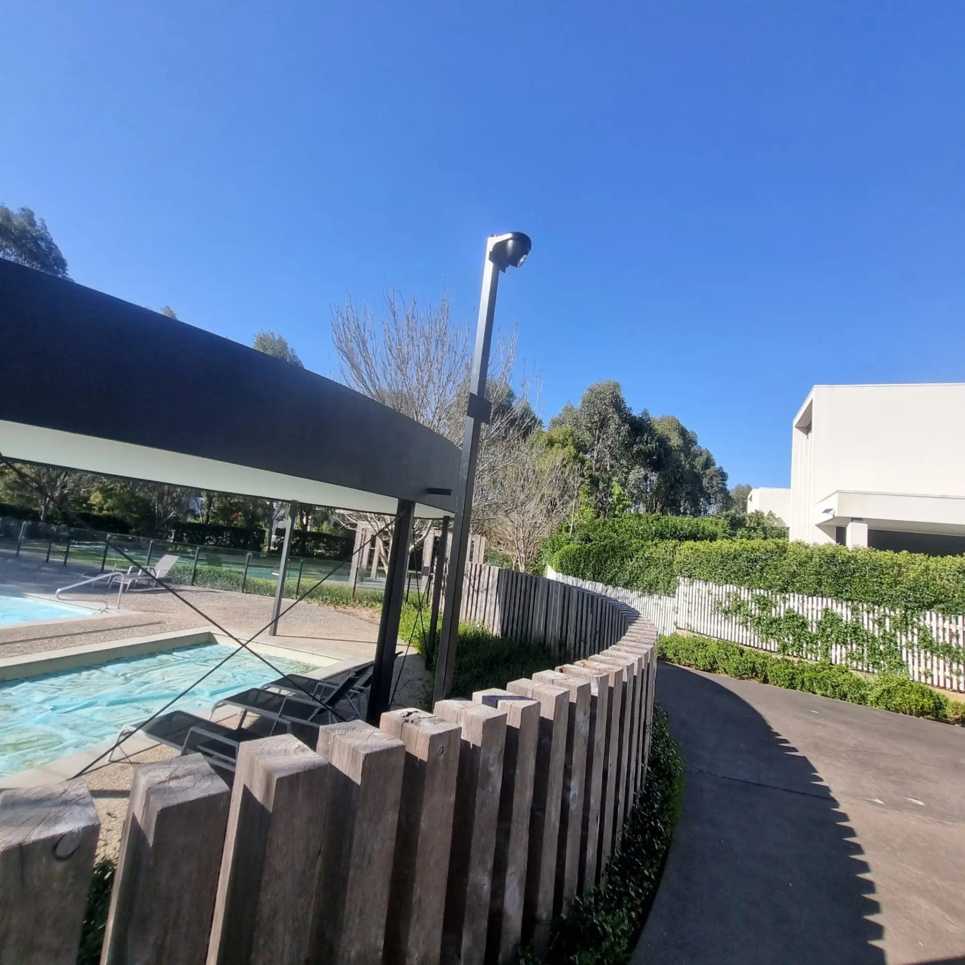 Pole-mounted camera covering a pool and outdoor area